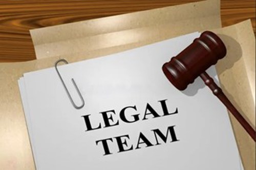 Close-up of a ‘Legal Team’ document with a judge’s gavel, symbolising legal expertise, compliance, and trusted advisory services.